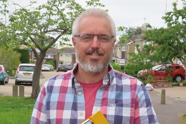 Councillor Richard Lee holding a clipboard