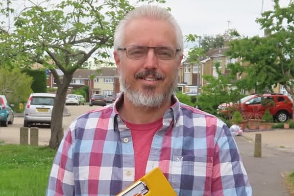 Councillor Richard Lee holding a clipboard