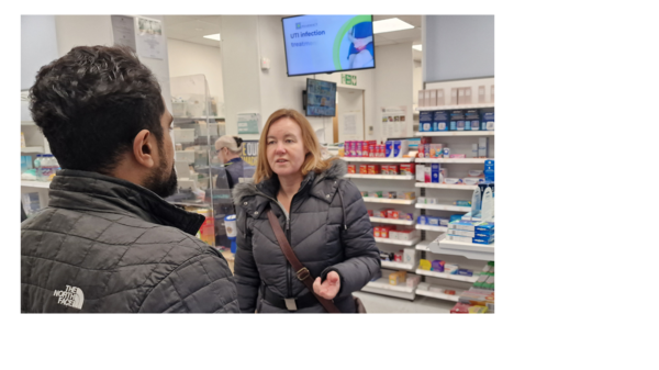 Marie Goldman MP talking to a pharmacist