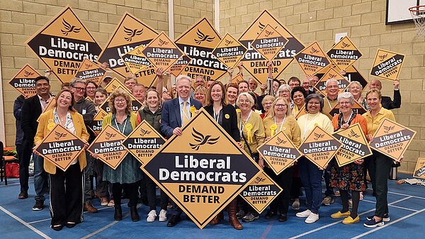 Photo of large group of Lib Dems smiling with diamonds