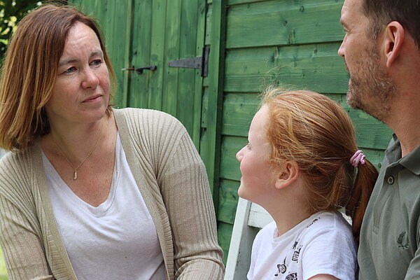 Marie with a young child and father
