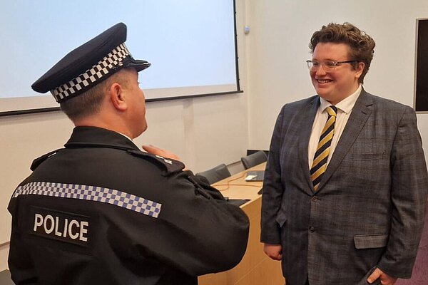 Cllr. Kieron Franks speaking with a police officer
